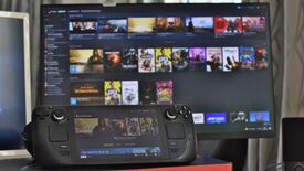 A Steam Deck in front of a desktop monitor, both showing their respective Steam UIs ready for Remote Play.