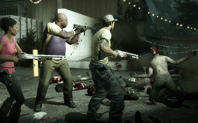 Three characters aim their guns at a zombie on the floor in Left 4 Dead 2