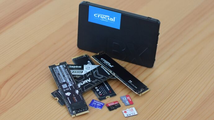 Various SSDs and microSD cards on a table.